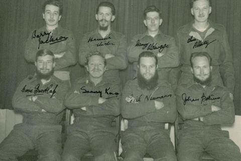 MARION 12 (November 1954-April 1956): Back (L-R) Barry Jackson (Diesel Mechanic), Hennie F. Vister (Cook), Danny Oldewage (Radio Technician), Chis P. Albertyn (Meteorologist); Front: Gerrie P. Borstlap (Meteorologist), C. Sarel Koch (Medic), Cecil Neumann (Radio Operator), Johan P. Bothma (Officer-in-Charge/Senior Meteorologist).