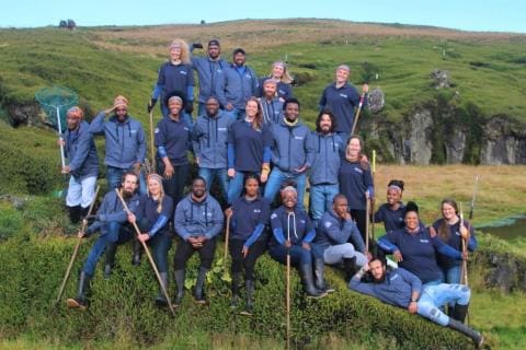 MARION 75 (2018-2019): Back (L-R) Charlotte Heijnis (Environmental Control Officer), Abuyiselwe Nguna (Geomorphologist and Science Team Leader), Michael Taunyane (Diesel Mechanic and Deputy Team Leader), Danielle Keyes (Birder), Stephan Keyes (Birder), Liezl Pretorius (Sealer and Deputy Science Team Leader); Middle Row: Jabulani Thabede (Chef), Maliviwe Melford Mnengisa (Medic and Team Leader), Oyena Masiko (Birder), Wilson Welly Qwabe (Sealer), Michelle Thompson (Birder), Vhulahani Manukha (SANSA), Michael Voysey (Killer Whaler/Sealer), Marike Louw (Botanist/Plant Ecologist); Front Row: James Burns (Meteorological Technician), Monica Leitner (Assistant Environmental Control Officer), Dakalo Gangashe (Base Engineer), Bongekile Kuhlase (Botanist), Zinhle Shongwe (Meteorological Technician), Sechaba Nyaku (Senior Meteorological Technician), Sean Morar (Birder), Dineo Mogashoa (Botanist/Winder), Bukelwa Mavis Lekhesa (Communications Engineer), Elsa van Ginkel (Botanist/Winder).